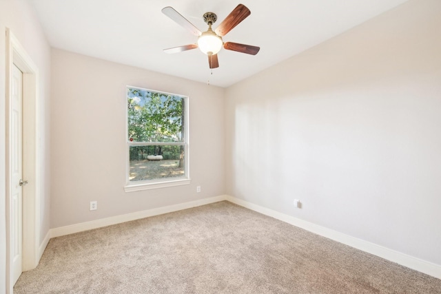 unfurnished room with light colored carpet, baseboards, and ceiling fan