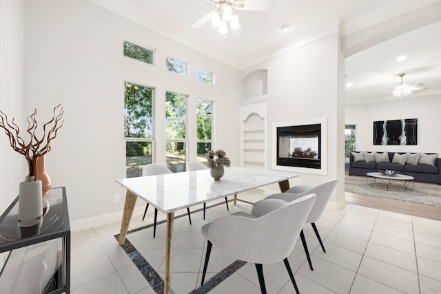 dining room featuring ornamental molding, a ceiling fan, and light tile patterned floors