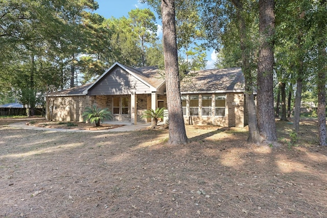 chalet / cabin with a porch and brick siding