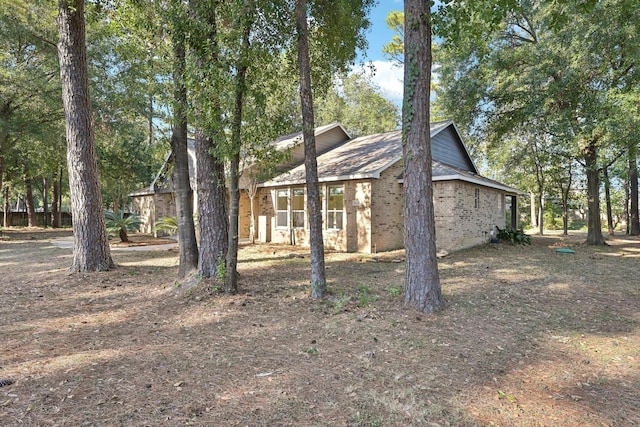 view of property exterior with brick siding