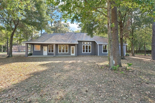 back of property featuring covered porch