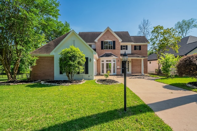 view of front of home with brick siding and a front lawn