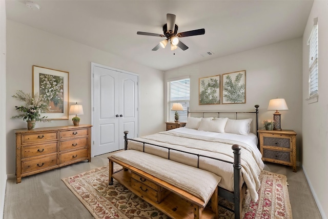 bedroom with a closet, baseboards, a ceiling fan, and visible vents