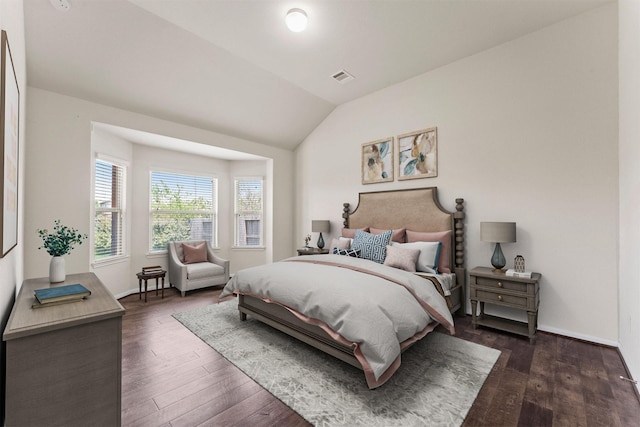 bedroom featuring baseboards, vaulted ceiling, dark wood-style flooring, and visible vents