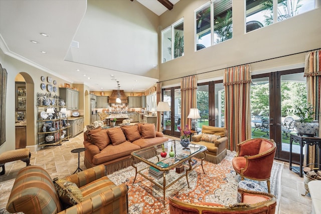 3410 Banbury Pl, Houston, TX 77027 - living room featuring french doors, arched walkways, a high ceiling, ornamental molding, and stone tile floors
