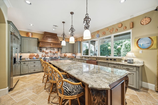 3410 Banbury Pl, Houston, TX 77027 - kitchen featuring tasteful backsplash, gray cabinetry, a sink, custom range hood, and stone tile floors