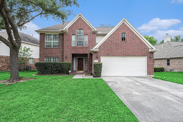 13134 Durbridge Trail Dr, Houston, TX 77065 - traditional home with a front yard, a shingled roof, an attached garage, concrete driveway, and brick siding