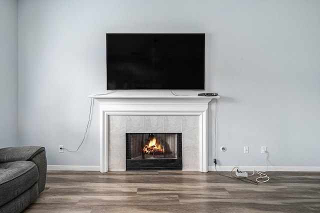 13134 Durbridge Trail Dr, Houston, TX 77065 - details with a tiled fireplace, baseboards, and wood finished floors
