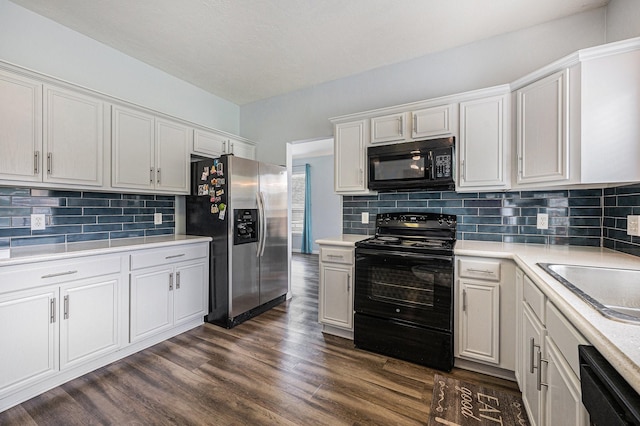 13134 Durbridge Trail Dr, Houston, TX 77065 - kitchen with white cabinets, tasteful backsplash, light countertops, and black appliances