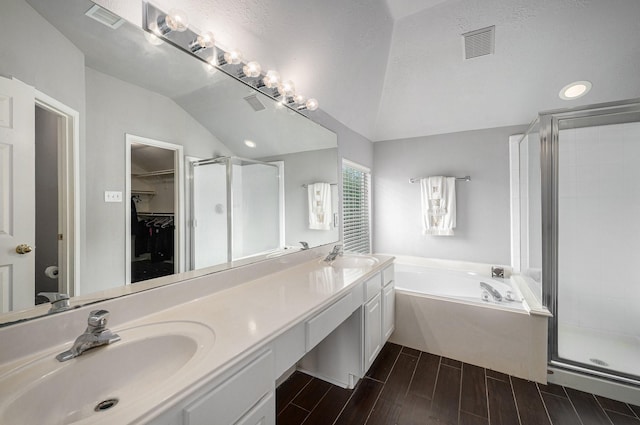 13134 Durbridge Trail Dr, Houston, TX 77065 - full bathroom featuring a shower stall, a bath, vaulted ceiling, visible vents, and a sink