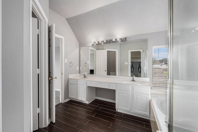 13134 Durbridge Trail Dr, Houston, TX 77065 - full bath with baseboards, a sink, double vanity, wood finished floors, and vaulted ceiling