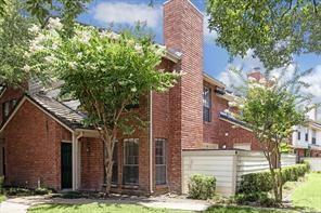 2211 S Kirkwood Rd Unit 9, Houston, TX 77077 - back of house featuring a chimney, brick siding, and fence