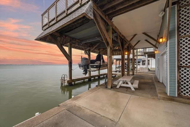 dock area with boat lift and a water view