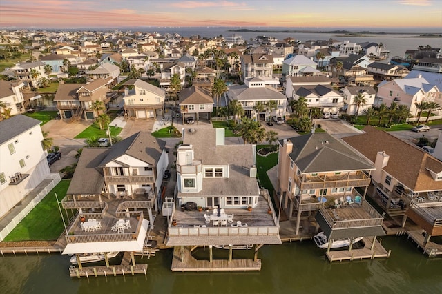 drone / aerial view featuring a residential view and a water view