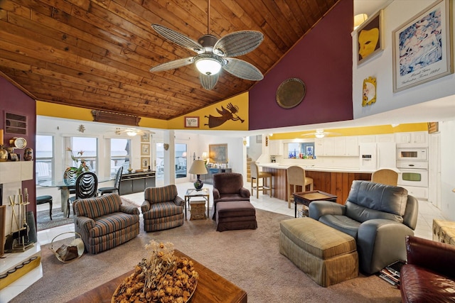 living area with high vaulted ceiling, ceiling fan, light colored carpet, and wood ceiling