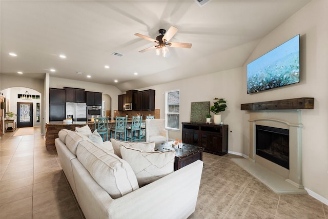 120 Brooke Addison Ct, Montgomery, TX 77316 - living room featuring visible vents, a ceiling fan, arched walkways, and light tile patterned floors