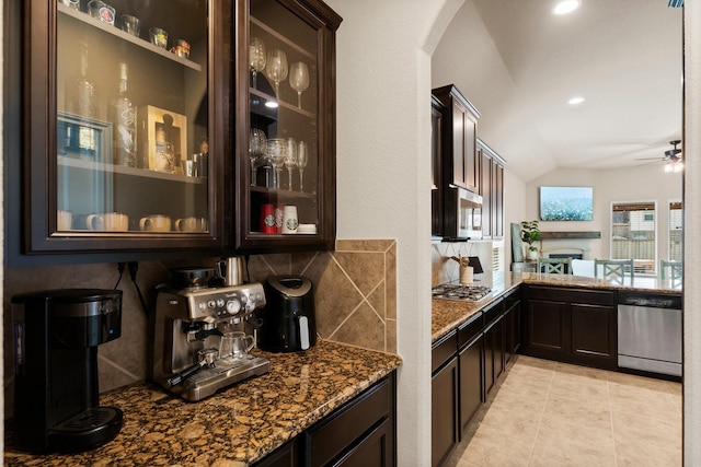120 Brooke Addison Ct, Montgomery, TX 77316 - bar featuring vaulted ceiling, ceiling fan, stainless steel appliances, arched walkways, and decorative backsplash