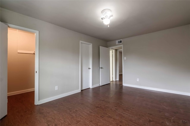 12046 Beechnut St, Houston, TX 77072 - unfurnished bedroom featuring dark wood-style flooring, baseboards, and visible vents