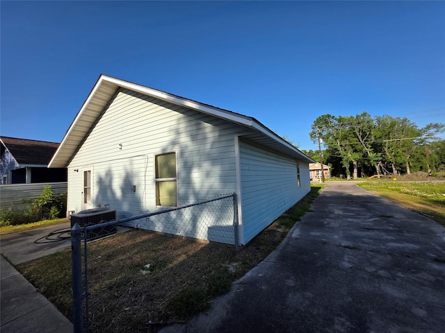 view of side of property featuring fence