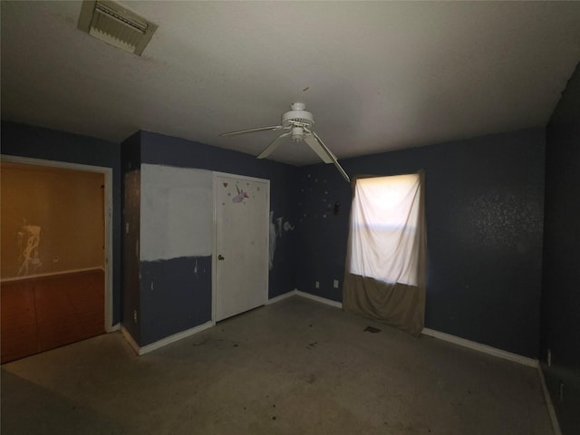 additional living space featuring concrete floors, visible vents, ceiling fan, and baseboards