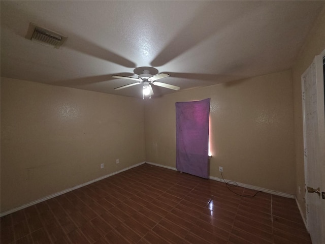 spare room with visible vents, baseboards, and a ceiling fan