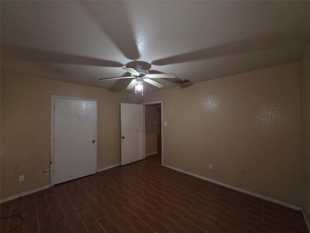 unfurnished bedroom with ceiling fan, baseboards, and visible vents
