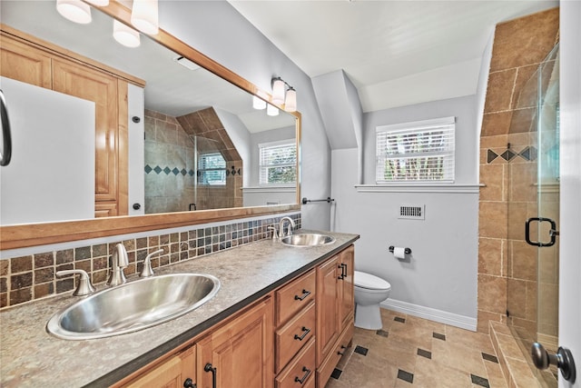 bathroom featuring a sink, tasteful backsplash, and a shower stall