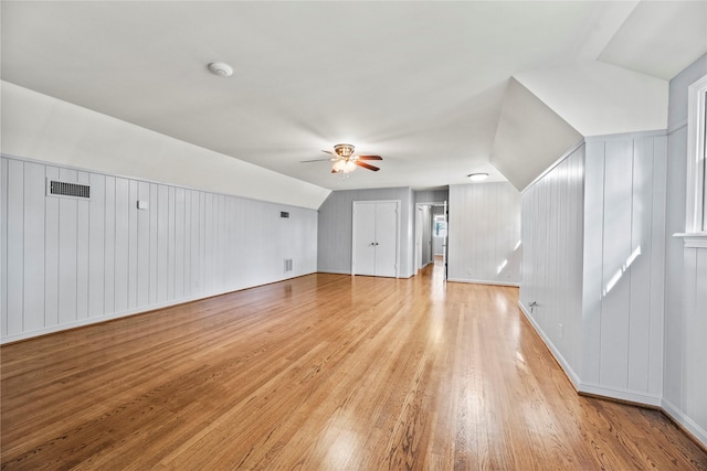 bonus room with ceiling fan, lofted ceiling, light wood finished floors, and visible vents