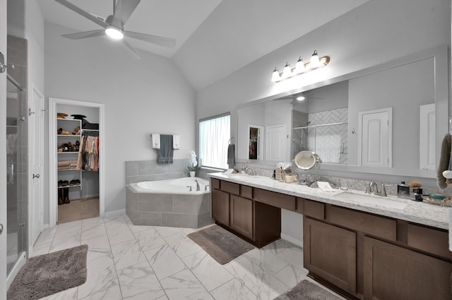 full bathroom featuring a sink, a spacious closet, a ceiling fan, and a stall shower