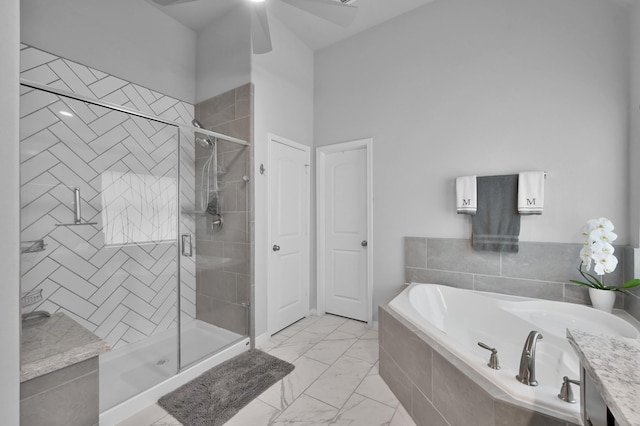 bathroom with marble finish floor, a garden tub, a ceiling fan, and a stall shower