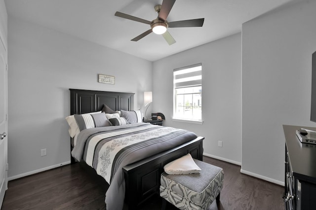 bedroom with baseboards, a ceiling fan, and dark wood-style floors