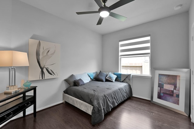 bedroom with wood finished floors, ceiling fan, and baseboards