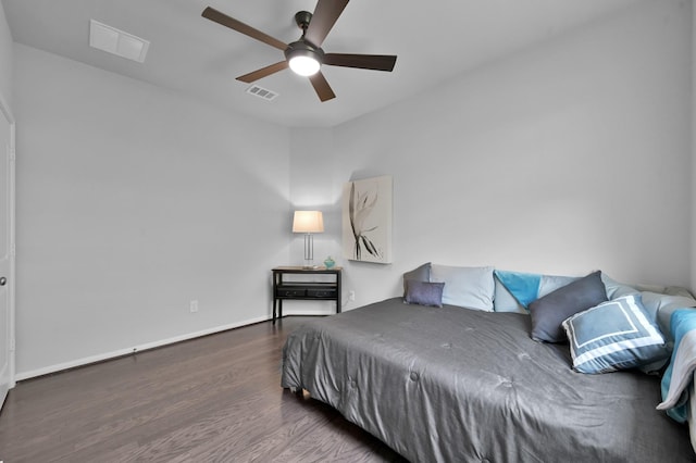 bedroom with visible vents, ceiling fan, baseboards, and wood finished floors