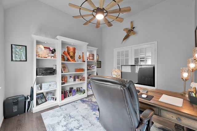 home office featuring wood finished floors, a ceiling fan, and high vaulted ceiling