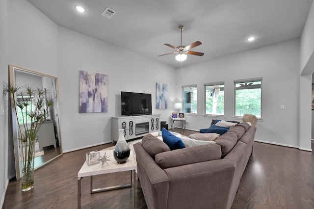 living room featuring baseboards, a ceiling fan, dark wood-type flooring, and visible vents