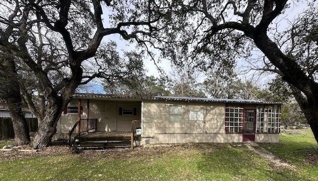 rear view of property with a yard