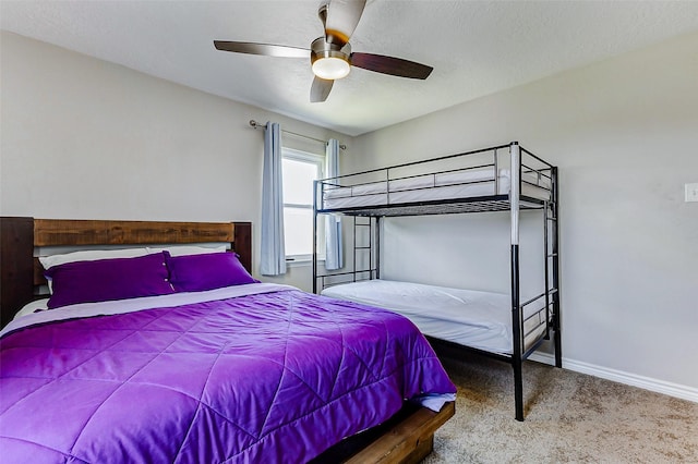 carpeted bedroom with baseboards and a ceiling fan