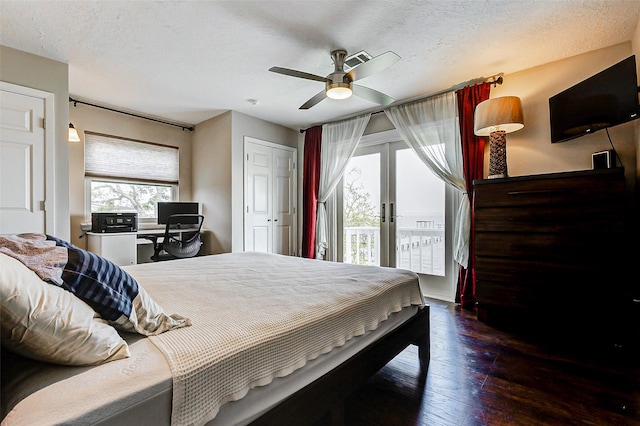 bedroom featuring access to outside, french doors, hardwood / wood-style floors, and a textured ceiling
