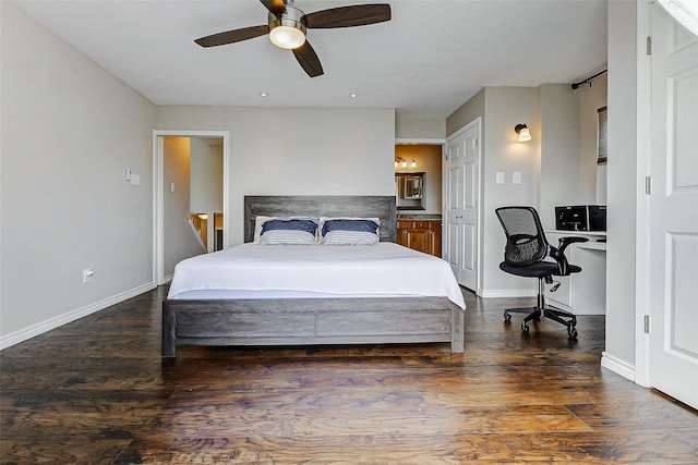 bedroom featuring wood finished floors, baseboards, and connected bathroom