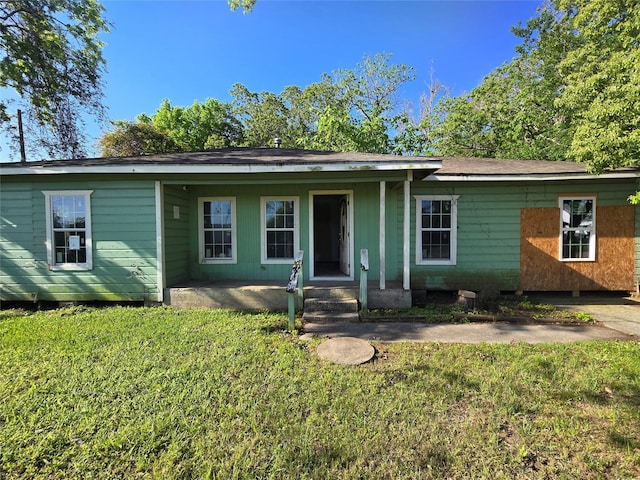 view of front of house featuring a front yard and covered porch