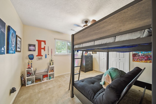 bedroom with baseboards, a textured ceiling, a ceiling fan, and carpet floors