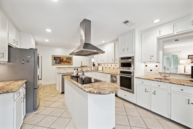 kitchen with visible vents, a center island, light tile patterned floors, appliances with stainless steel finishes, and island exhaust hood
