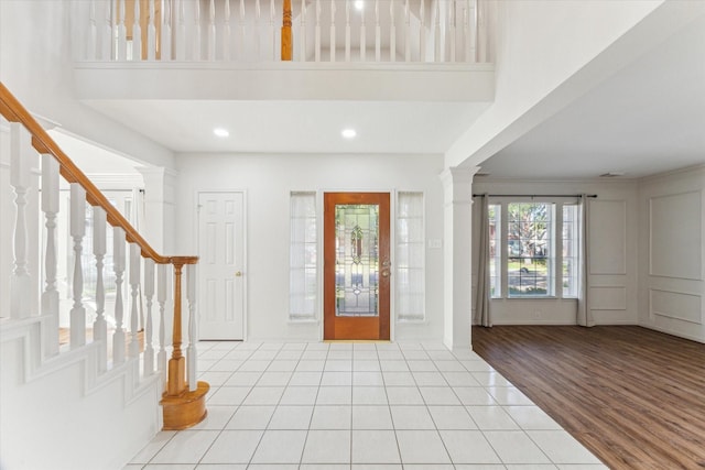 foyer featuring decorative columns, stairs, recessed lighting, and light tile patterned flooring
