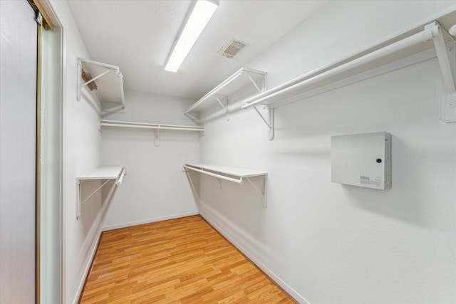 walk in closet featuring light wood finished floors and visible vents