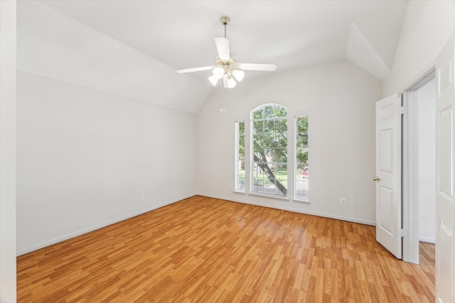 unfurnished bedroom featuring baseboards, a ceiling fan, light wood-style floors, and lofted ceiling