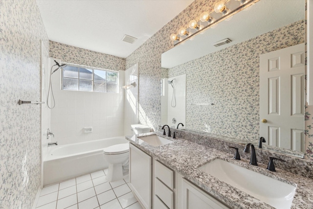 bathroom with tile patterned flooring, a sink, toilet, and shower / washtub combination