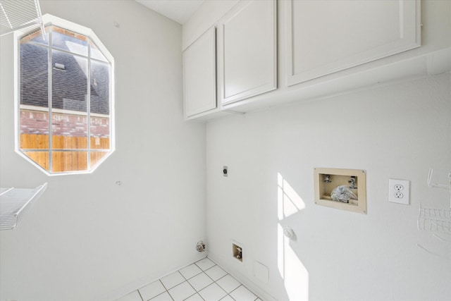 laundry room with hookup for an electric dryer, light tile patterned floors, washer hookup, and cabinet space