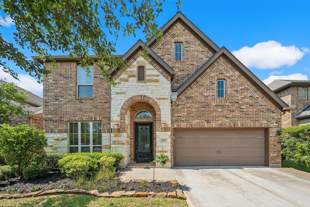 122 Verismo Ct, Montgomery, TX 77316 - view of front of home featuring brick siding, stone siding, a garage, and concrete driveway