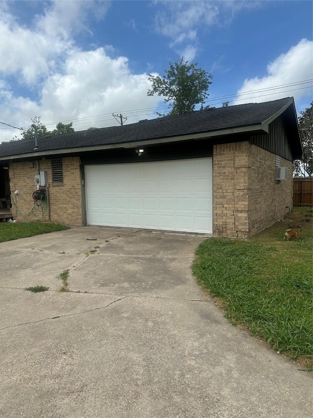 garage featuring concrete driveway