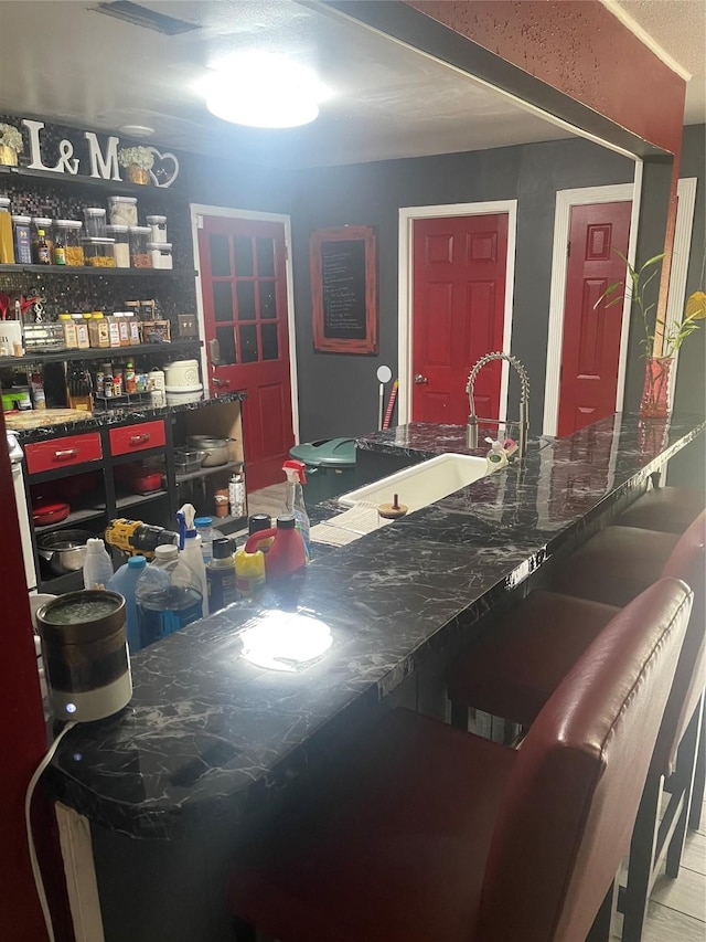 interior space featuring a sink and a kitchen bar